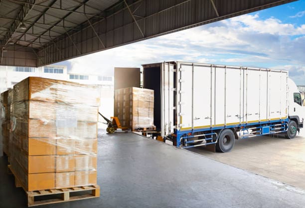 A truck is parked in the middle of an industrial area.